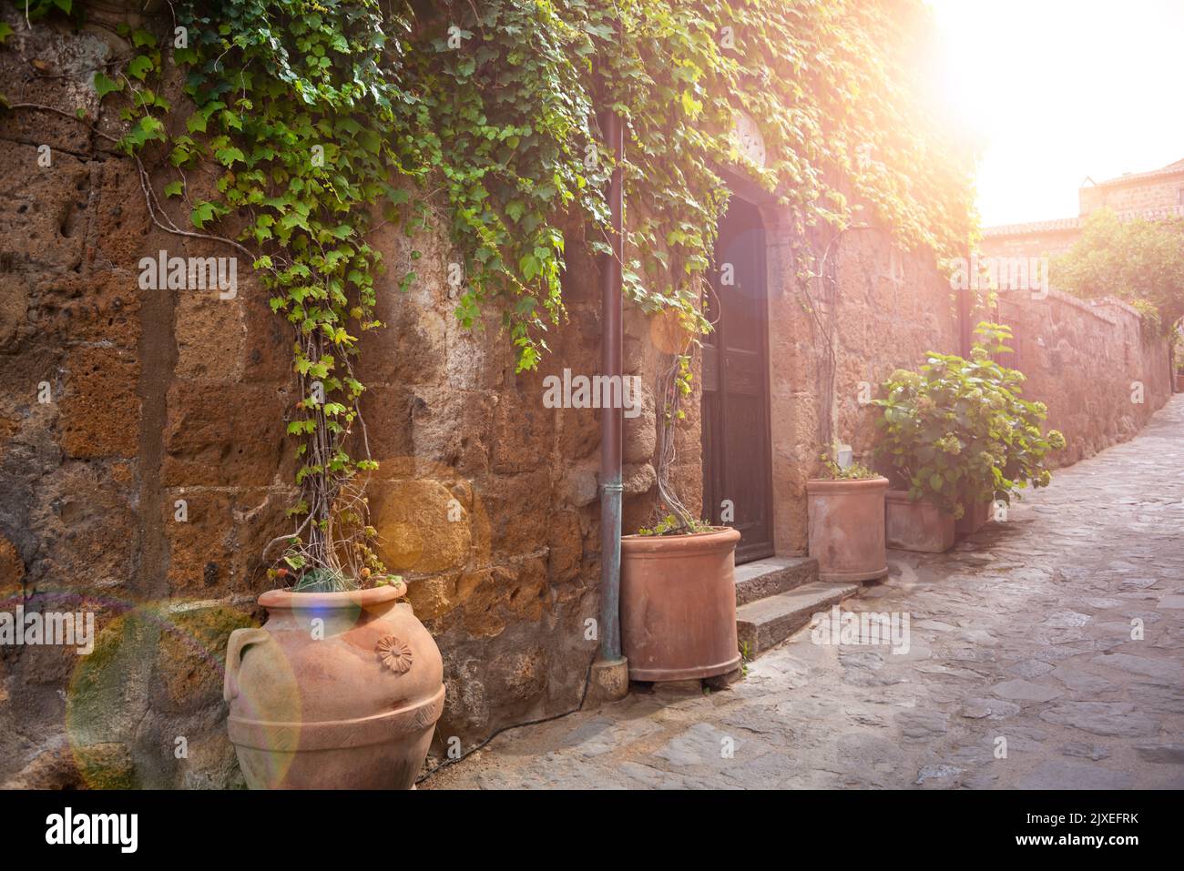 Picturesque street in medieval town in Tuscany, Italy. Old stone walls ...