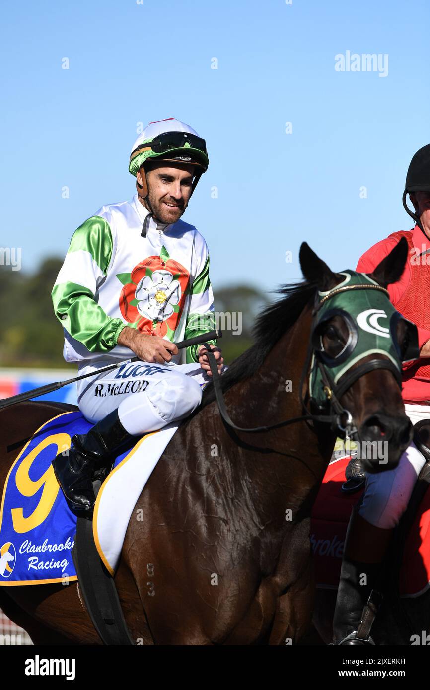 Jockey Rhys McLeod rides Hellava Babe back to scale after winning race ...