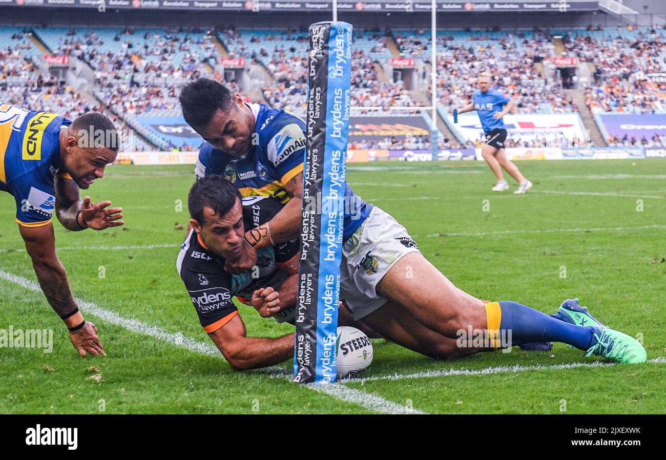 Corey Thompson (centre) for the Tigers scores against the Eels during ...
