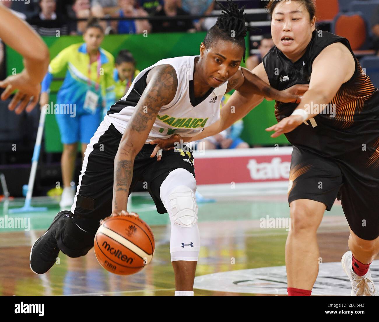 Jamaica's Shenneika Smith (left) rounds Malaysia's Phey Chyi Magdalene