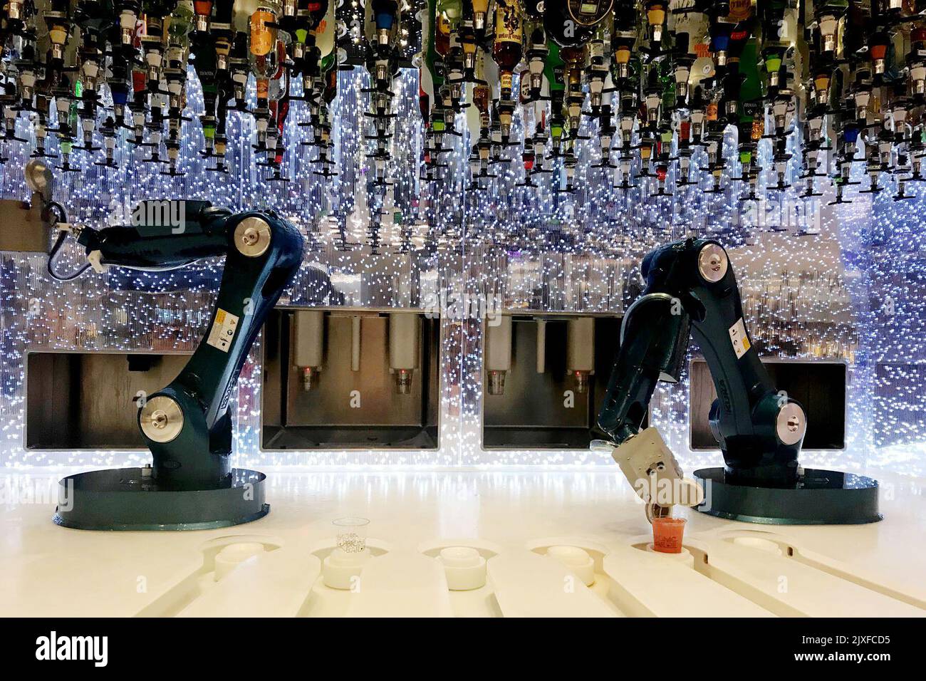 Two robots serve guests at the 'Bionic Bar' on board Royal Caribbean's ...