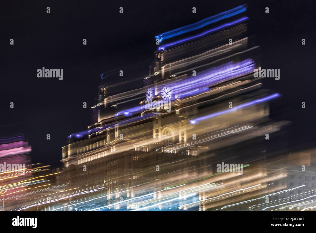 Etherial Liverpool Royal Liver building and waterfront at night with flowing light trails. Stock Photo