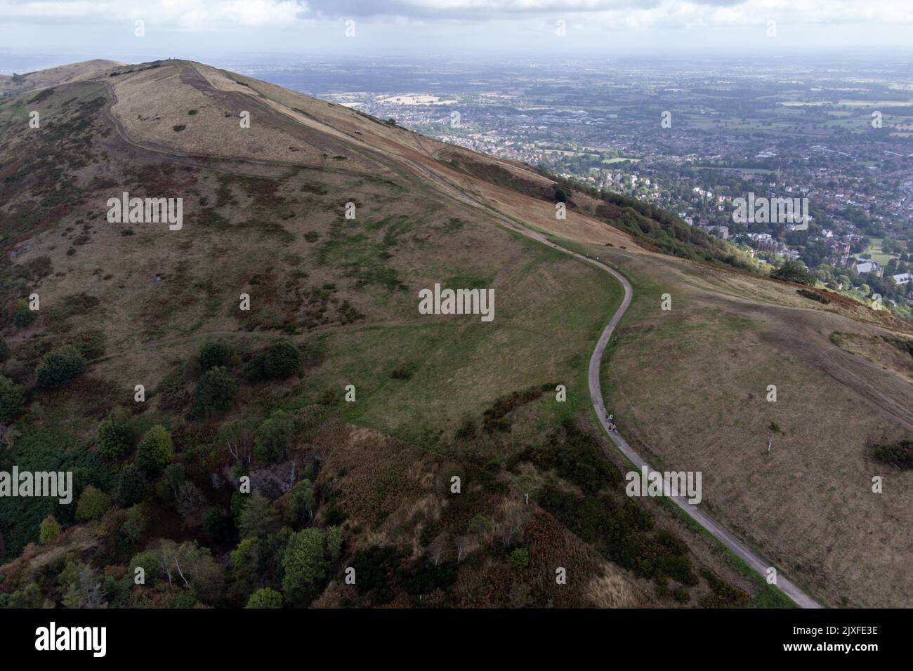 People walk along the Malvern Hills overlooking Great Malvern, in ...