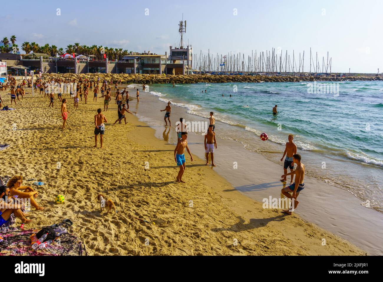 Tel-Aviv, Israel - June 17, 2022: Beach scene with visitors in various activities, in Tel-Aviv, Israel Stock Photo