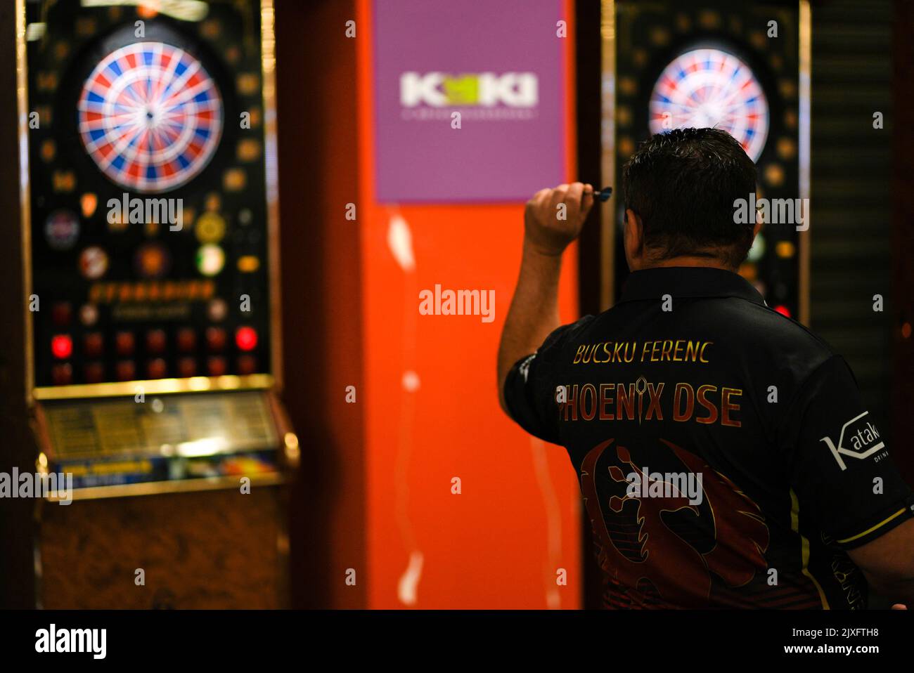 Black darts player aiming at a darts board in a pub Stock Photo Alamy