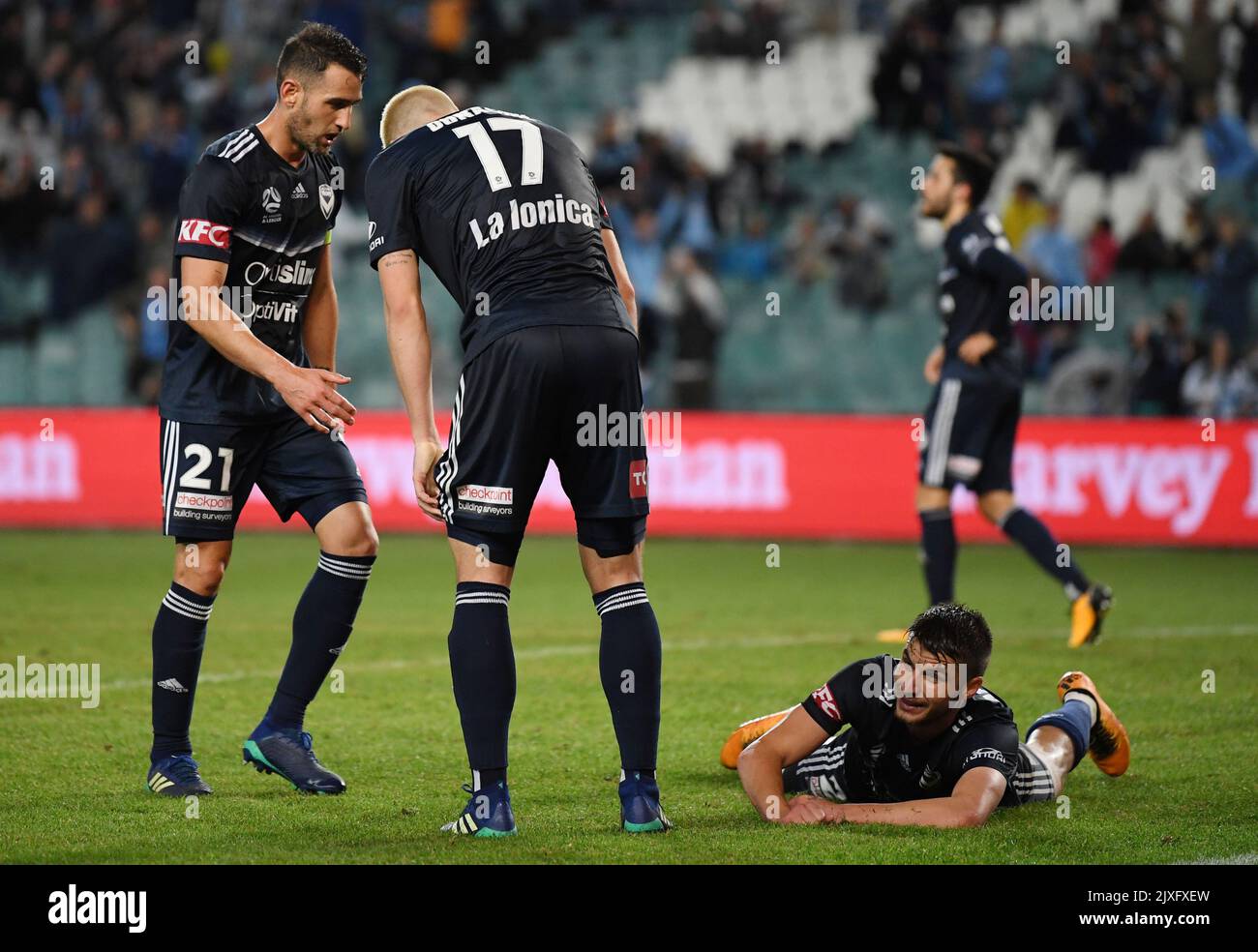 Terry Antonis of the Victory (right) lays on the ground after his own