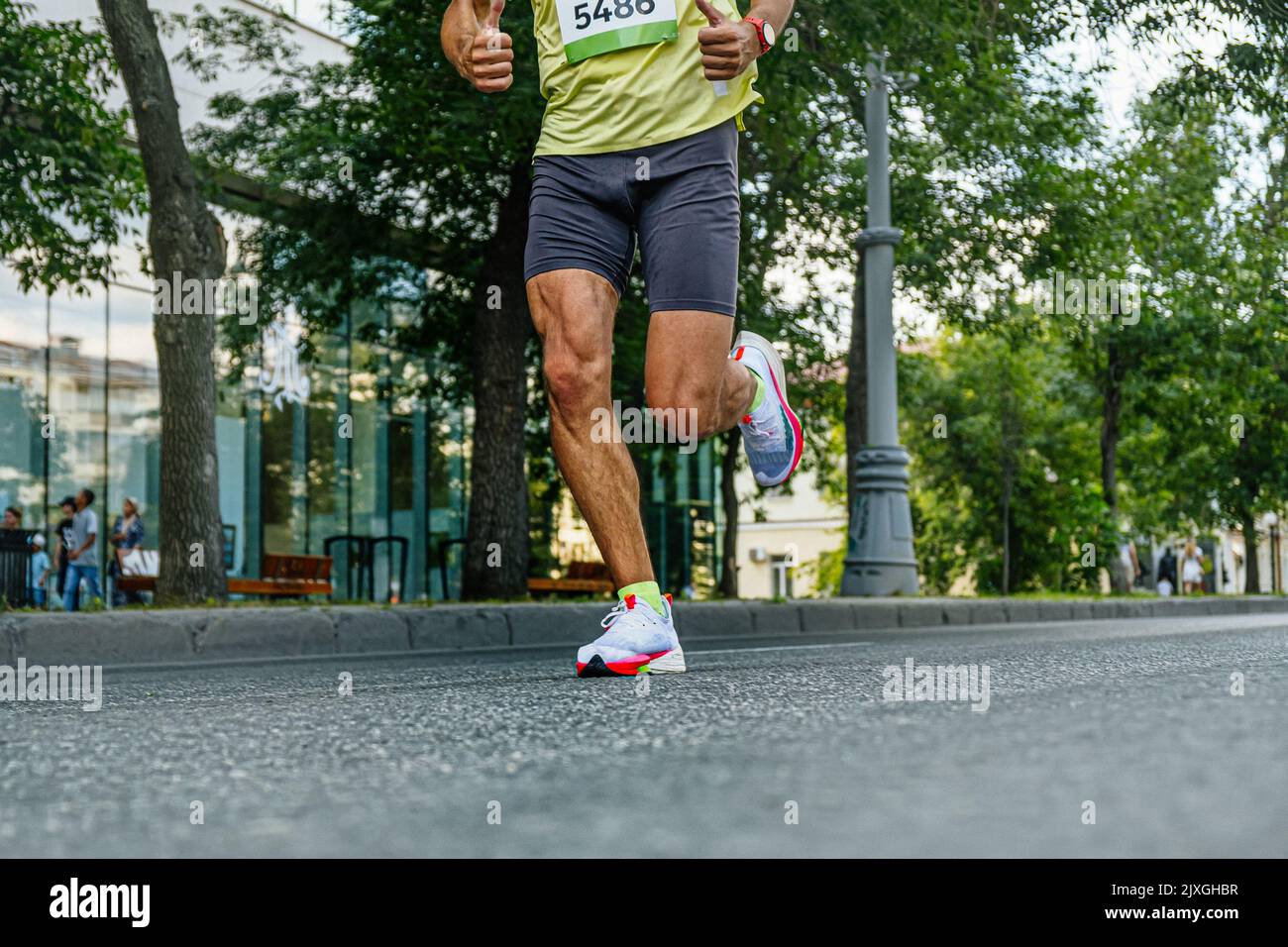legs runner athlete running street marathon Stock Photo