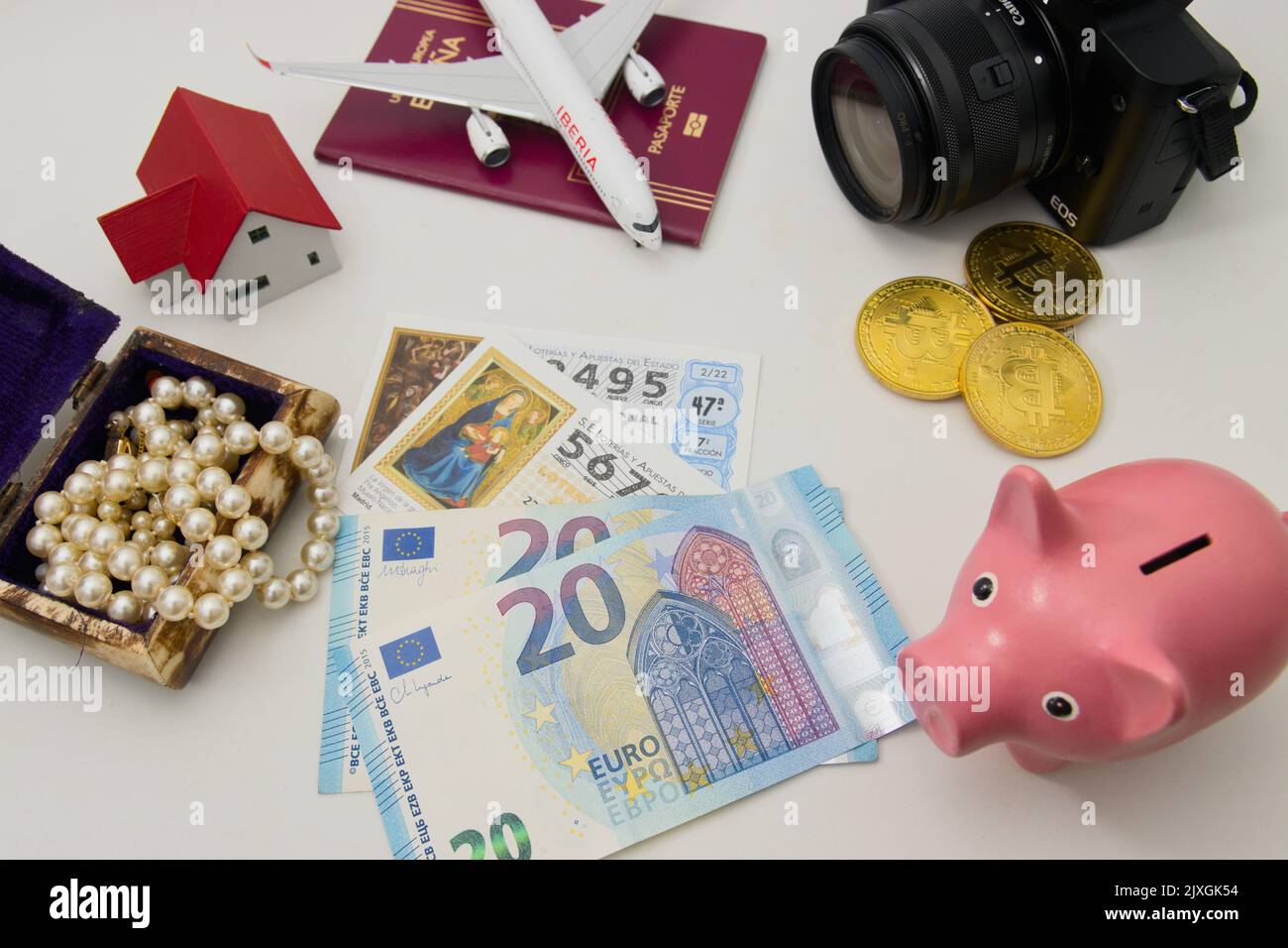 2022. Spain. Flat lay of a table with the options that exist after becoming a millionaire money, jewelry, travel, real estate investments, luxury, tec Stock Photo