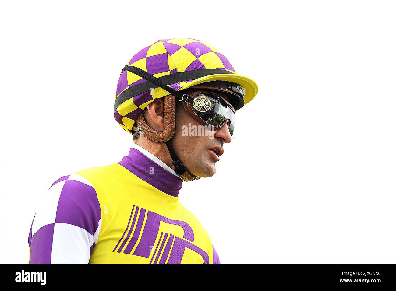 Jockey Corey Brown makes his way to the stalls ahead of race 5, the