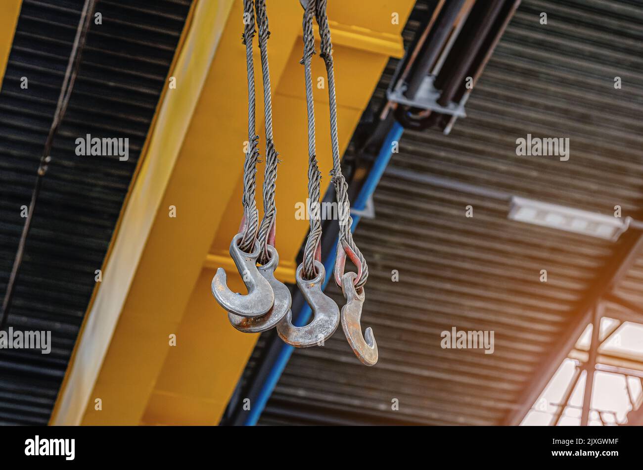 Metal hooks of lift in assembly shop. Lifting device, lifting hook at