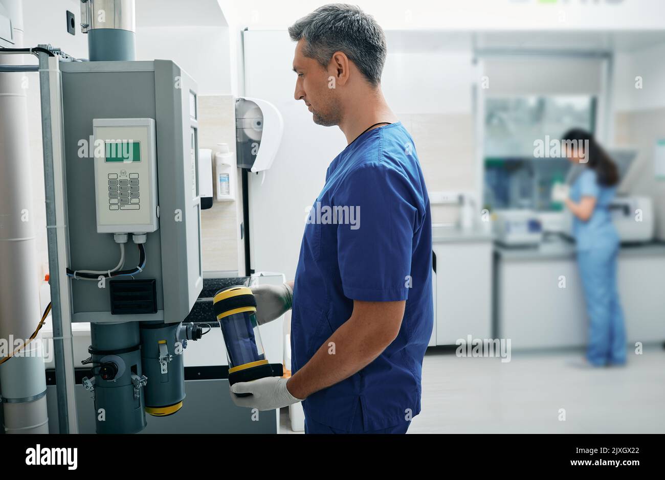 Laboratory assistant sends results of patient's lab tests to attending physician using pneumatic