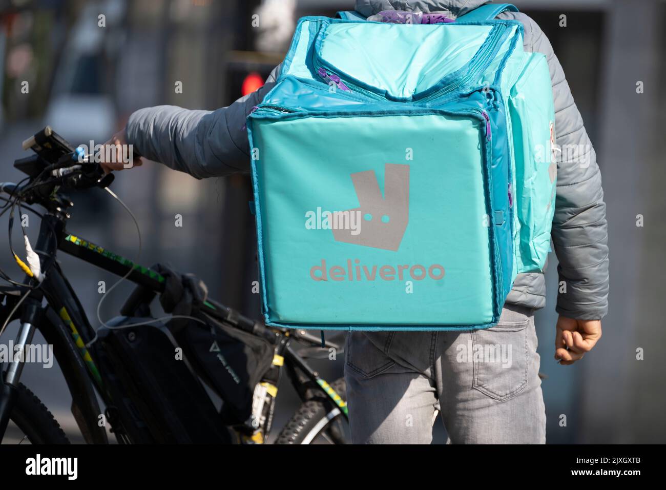 A rear view of a Deliveroo rider in Cardiff, United Kingdom. Stock Photo