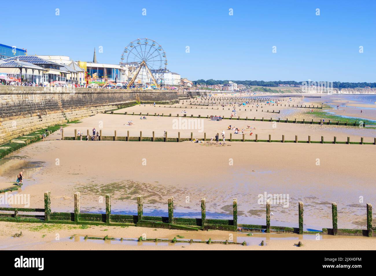 Bridlington Beach Yorkshire with groynes North beach and funfair on