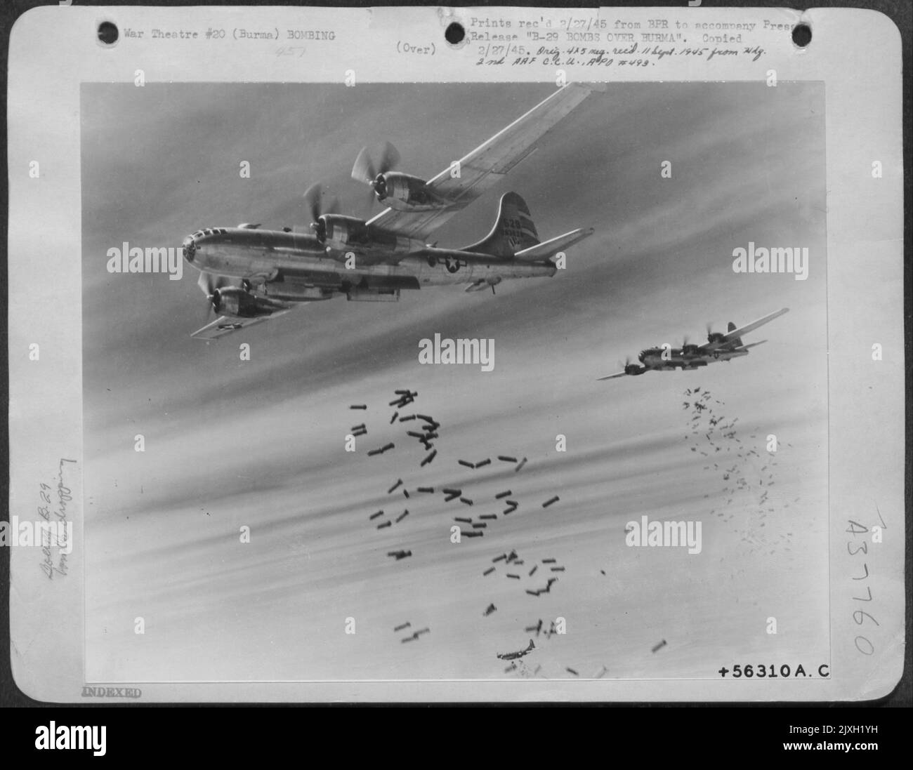 B-29 Bombs Over Burma (No.1) - Tons Of Bombs Speckle The Sky Over Rangoon, Burma, As They Spew From The Yawning Bomb Bays Of 20Th Bomber Command Superfortresses. The Target Of This Daylight Attack By Brig. Gen. Roger M. Ramsey'S India-Based Airman Was A Stock Photo