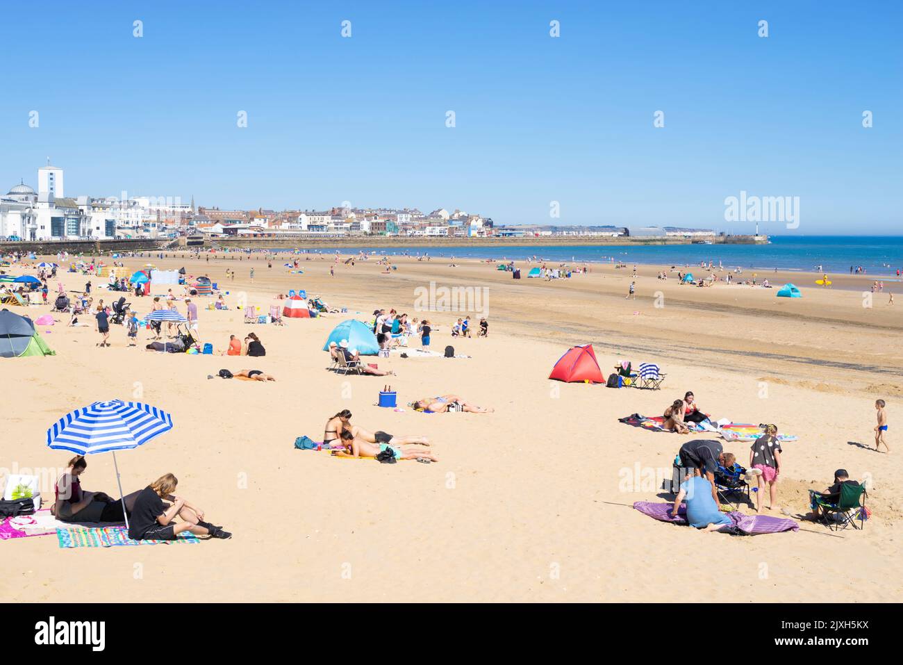 Bridlington South Beach with tourists holidaymakers and people sunbathing on the beach Bridlington East Riding of Yorkshire England UK GB Europe Stock Photo
