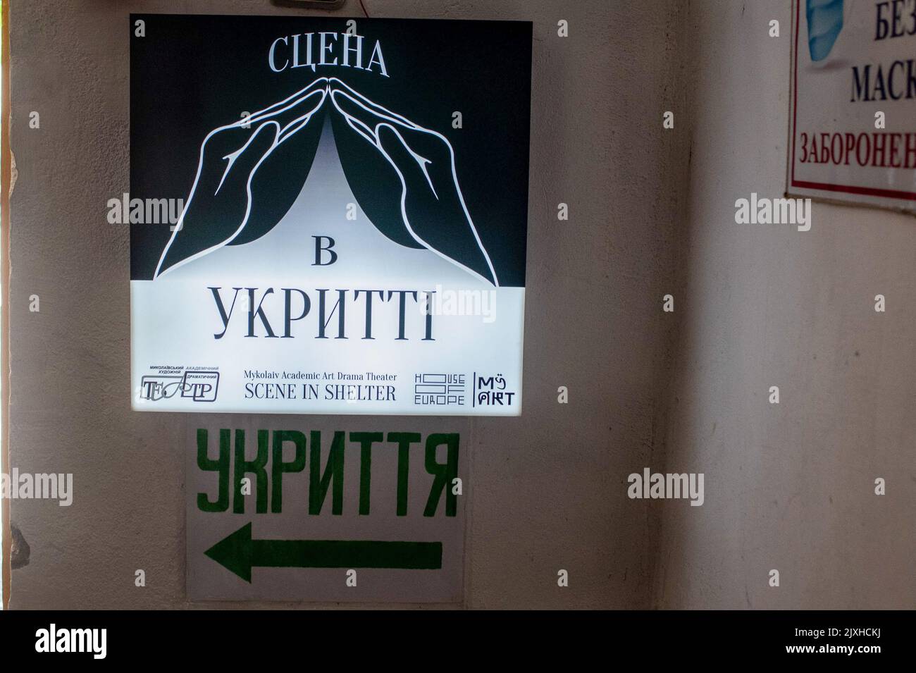 A sign seen at the air-raid shelter where theatre artists performed their plays during the Russian siege of the city of Mykolaiv. The Mykolaiv theatre has turned 100 years old, the war will not stop its wonderful work. Stock Photo