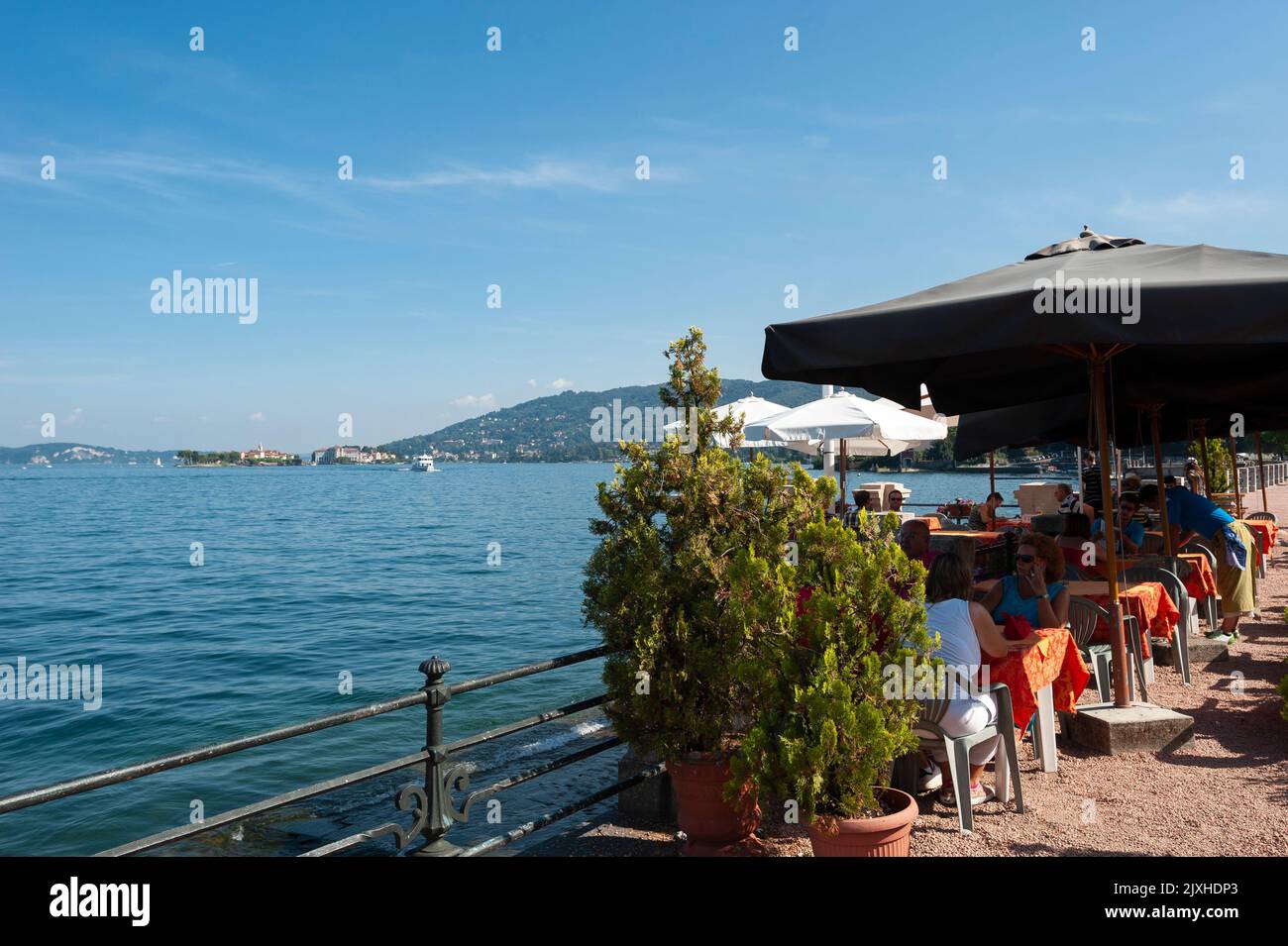 Restaurant on the promenade of Lake Maggiore, with the Borromean Islands in the background, Baveno, Piedmont, Italy, Europe Stock Photo