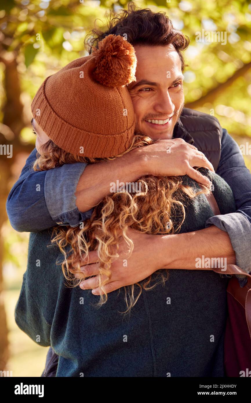 Happy Loving Couple Meeting And Hugging In Autumn Park Stock Photo - Alamy