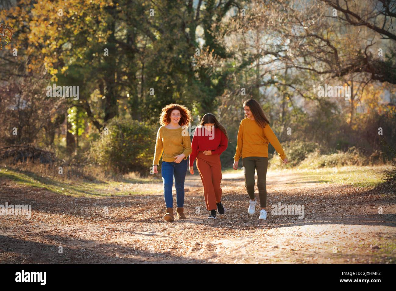 Group of teenage girls walking the streets and laughing. Stock Photo