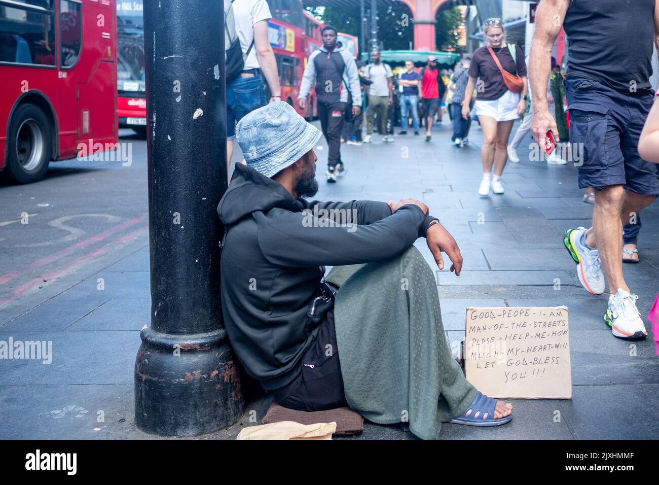 London- August 2022: A homeless man begging on the street of Brixton in south west London Stock Photo
