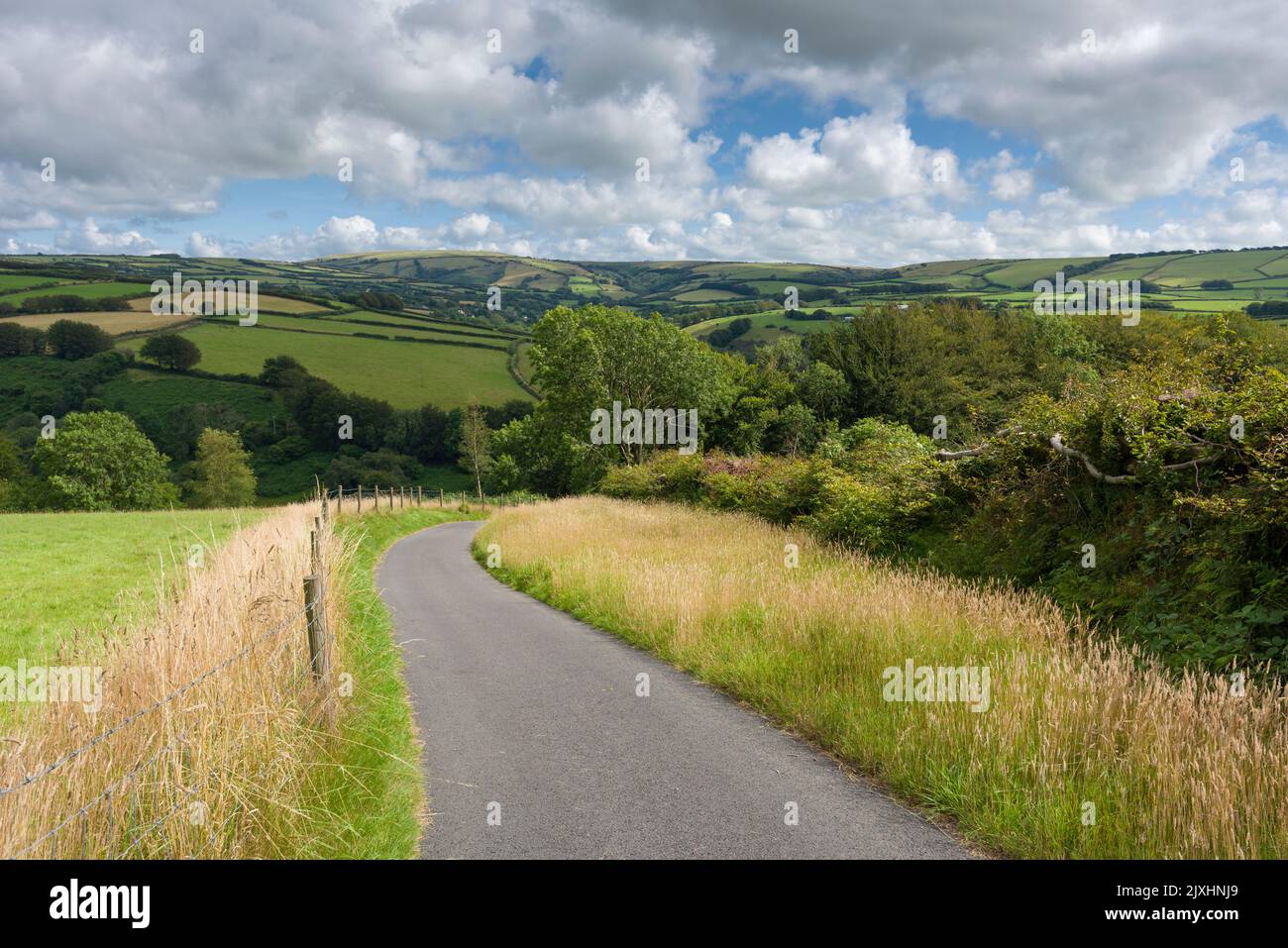 A country lane on Heale Down with the Heddon Valley and the hills of Challacombe Common beyond, Exmoor National Park, North Devon, England. Stock Photo