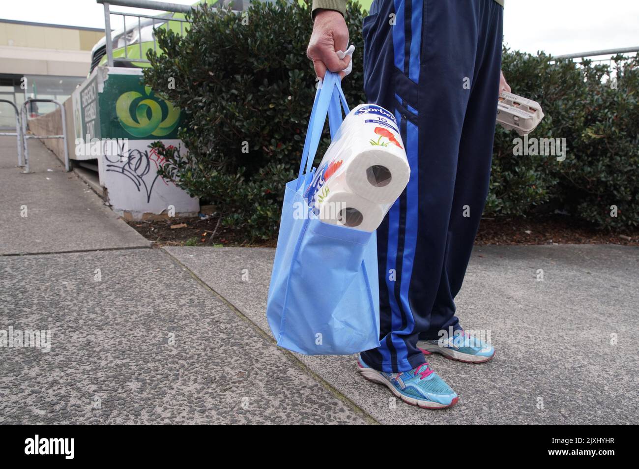 A customer is seen using a reuseable shopping bag at a Woolworths in