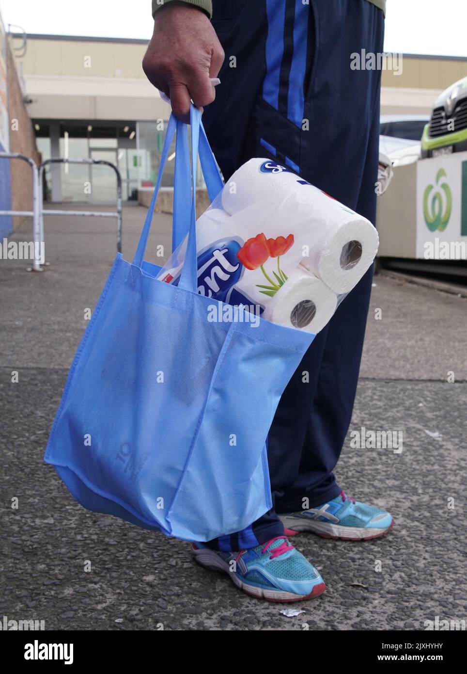A customer is seen using a reuseable shopping bag at a Woolworths in