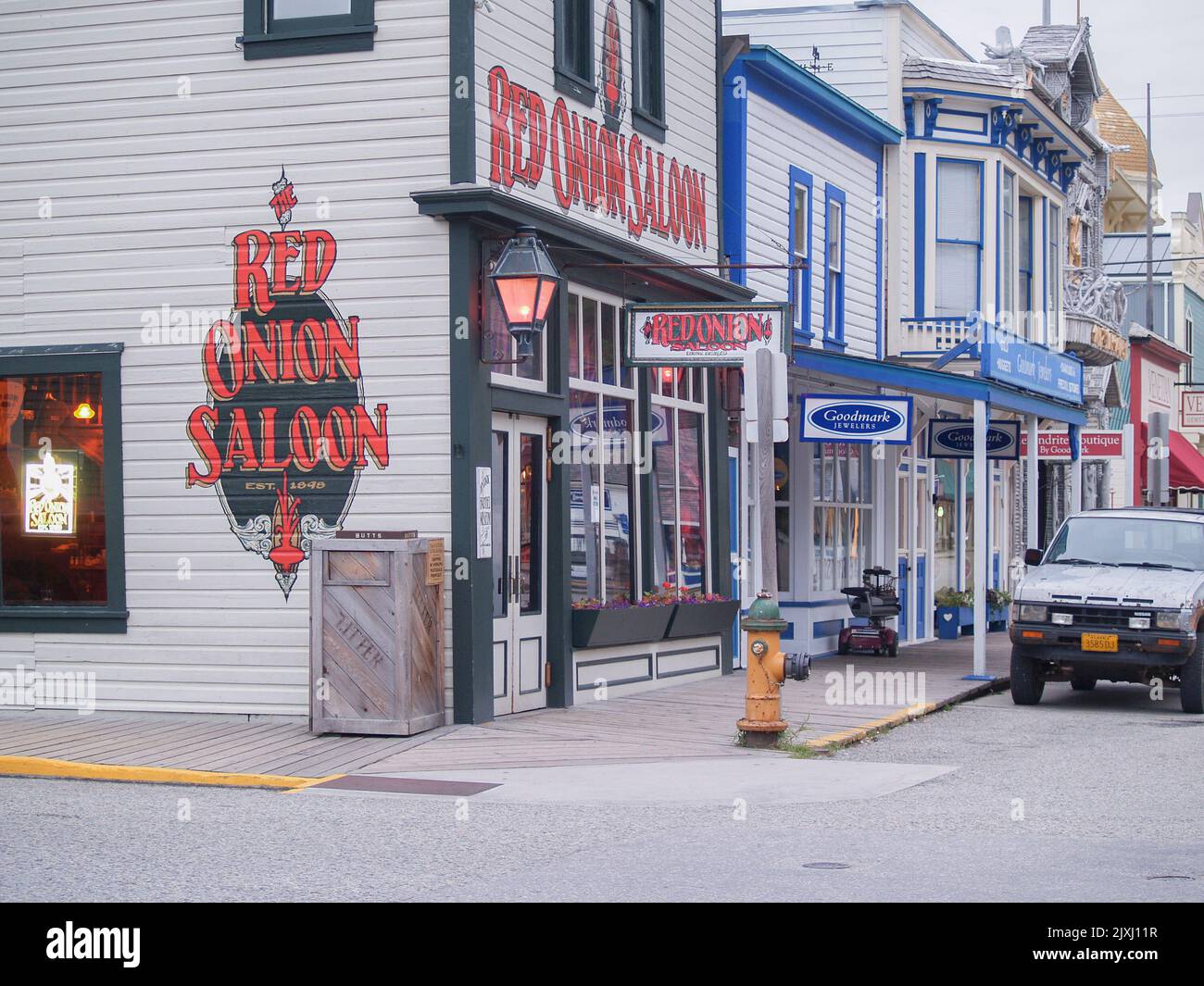 Skagway Alaska USA - August 2 2008;City street with old style building facades and sign for Red Onion Saloon Stock Photo