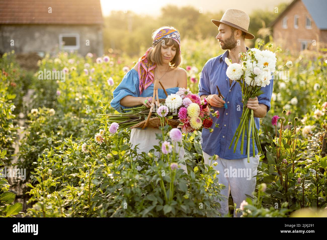Man and woman pick up flowers at farm outdoors Stock Photo Alamy