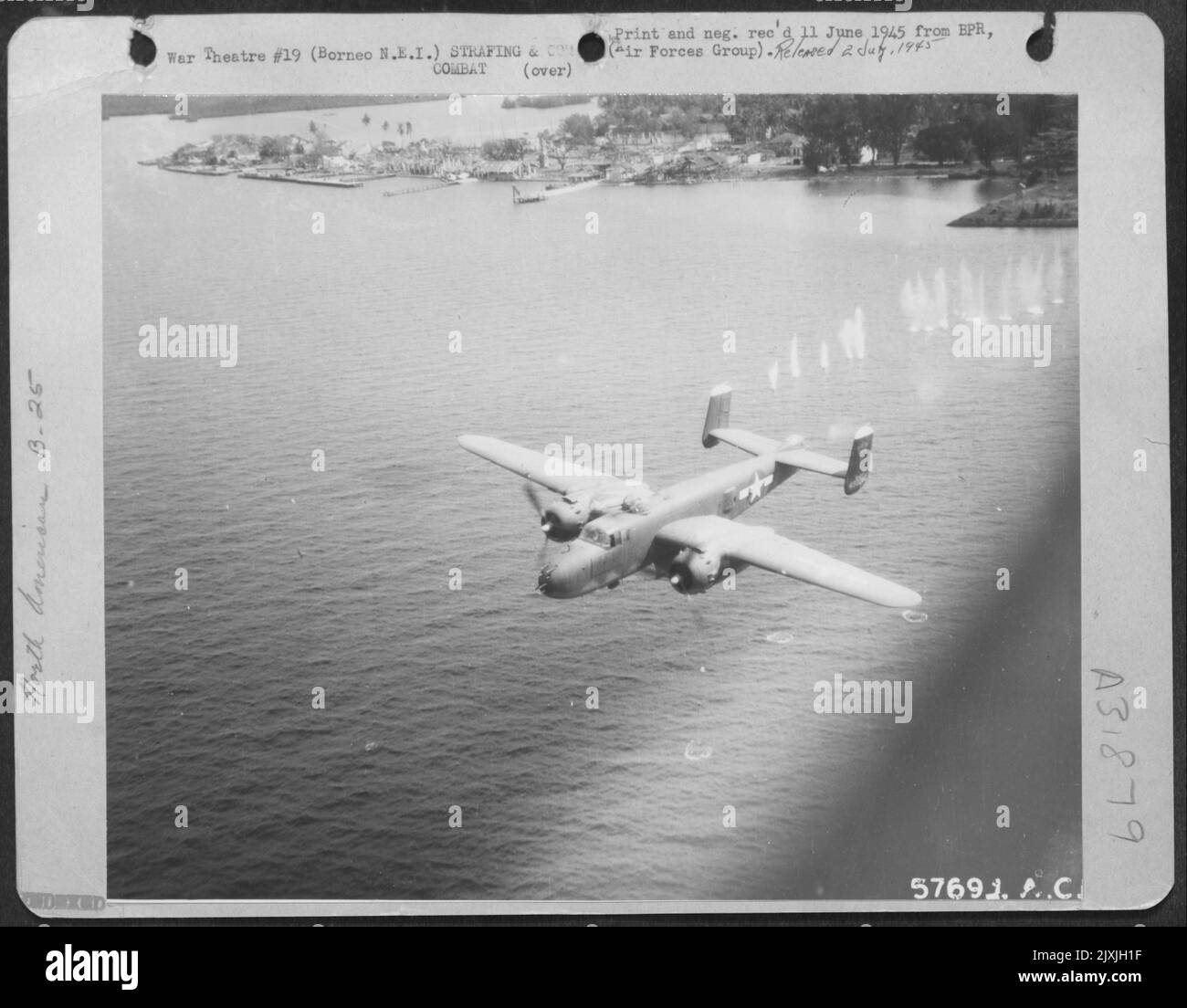 Japanese Machine Gun Bullets Furrow The Water Behind This 13Th Aaf North American B-25 Mitchell Medium Bomber As It Speeds To Safety After A Tree-Top Level Bombing And Strafing Attack On The Seaplane Anchorage At Victoria Harbor, North Borneo. The Plane'S Bom Stock Photo