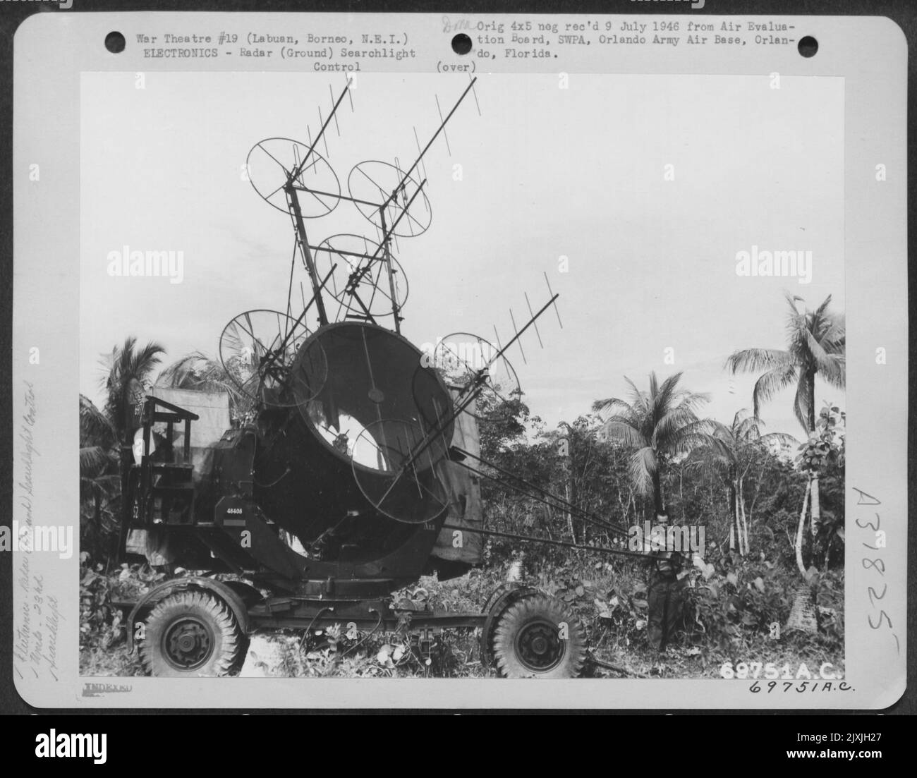 This Radar Searchlight Of The 23Rd Anti-Aircraft Searchlight Battalion Is The Lead Light; It Quickly Spots The Plane And Other Searchlights Then 'Pick Up' The Plane In A 'Cross Fire'. Labuan, Borneo, Netherland East Indies, 17 June 1945. Stock Photo
