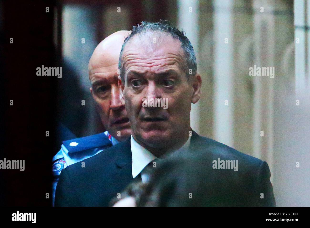 Angelo Russo is seen being loaded into a prison van as he leaves the ...