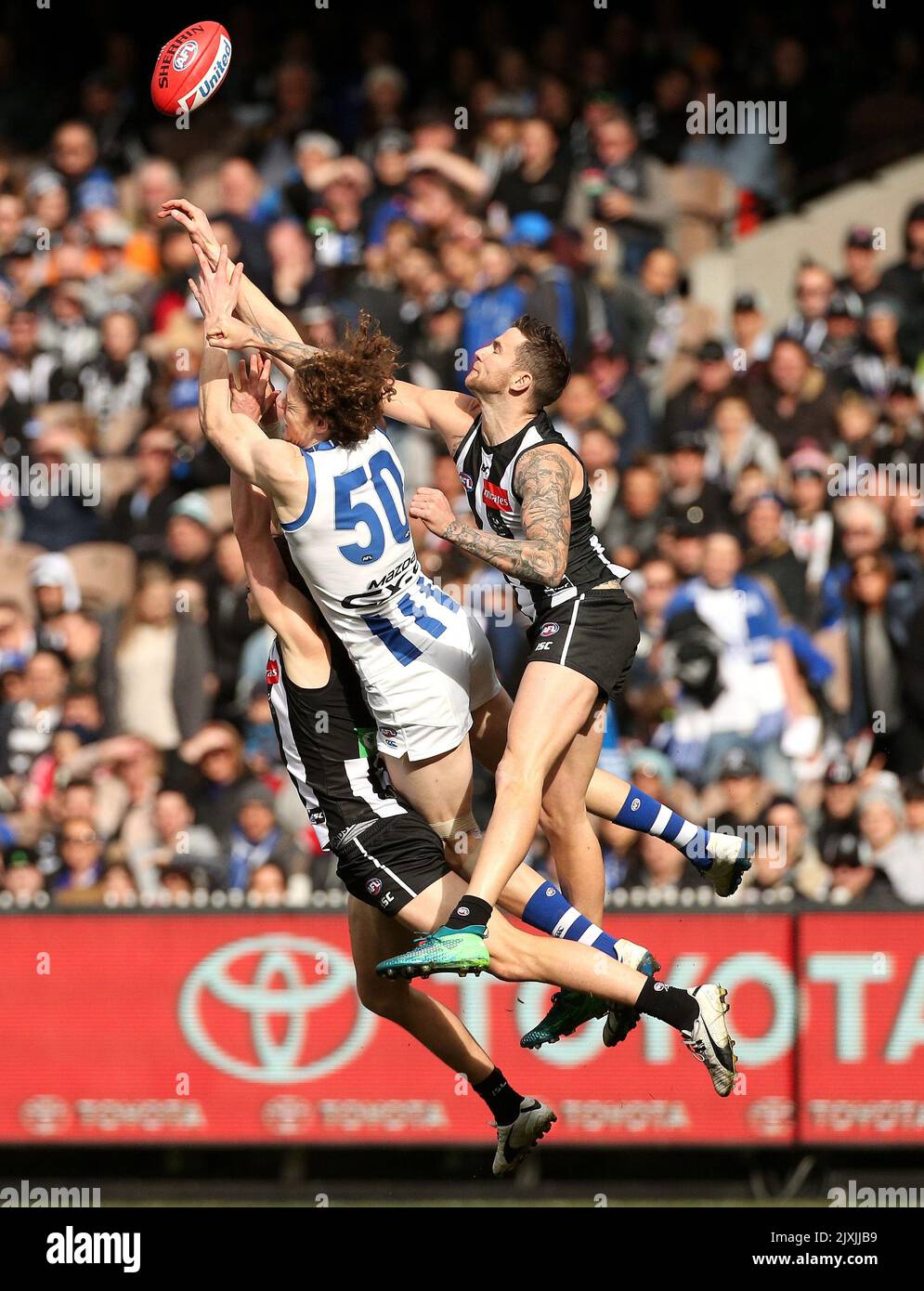 Tom Ropes Mcg Ben Brown of the Kangaroos (centre) competes in the air against Tom ...