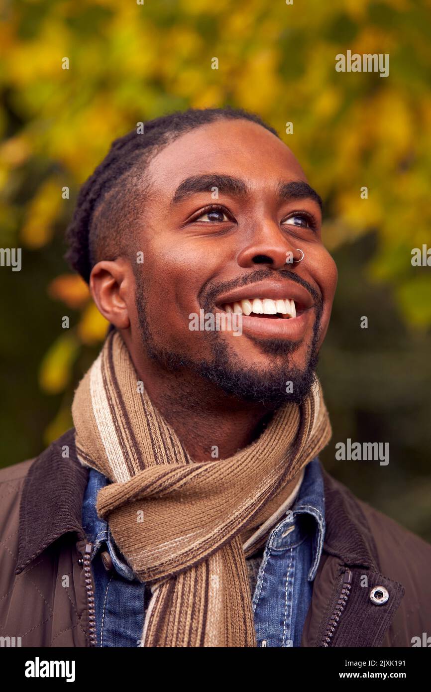 Head And Shoulders Portrait Of Man On Walk Through Autumn Countryside Against Golden Leaves Stock Photo