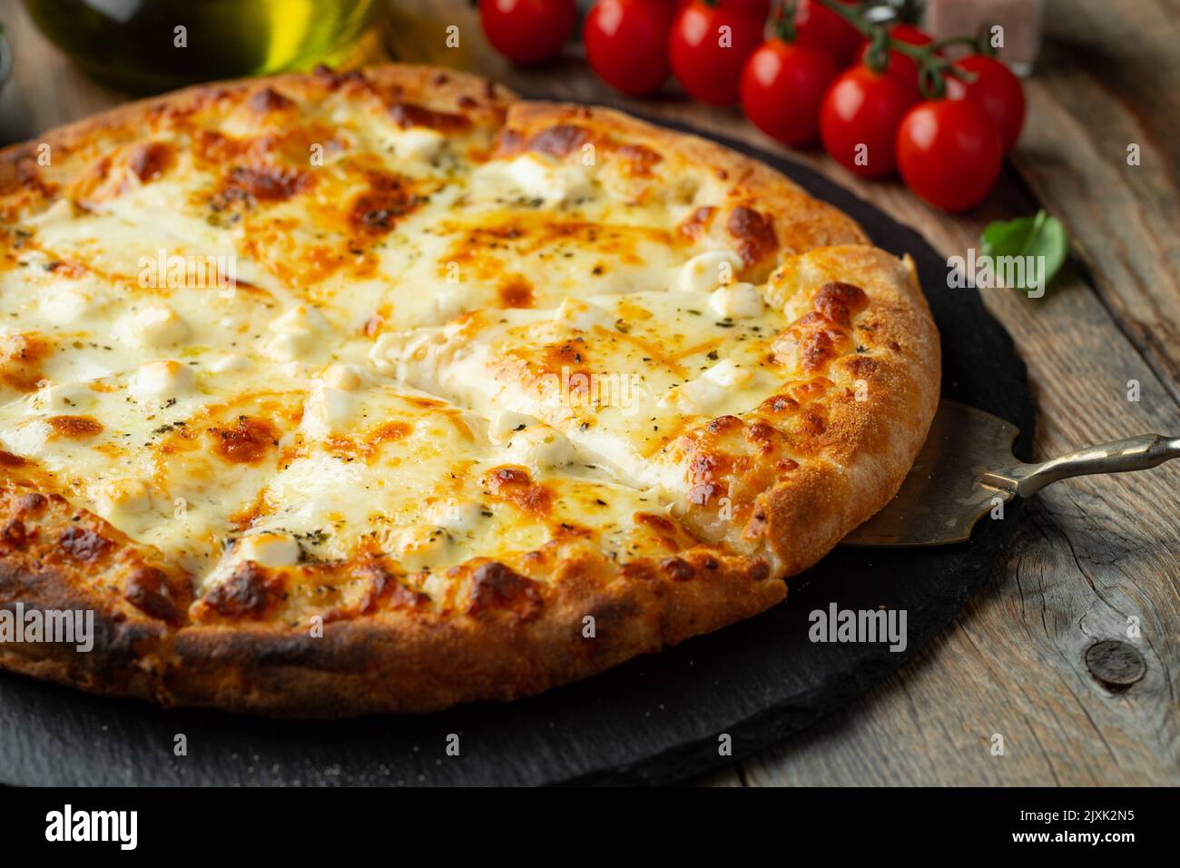 A slice of hot Italian pizza with stretching cheese. Pizza four cheeses