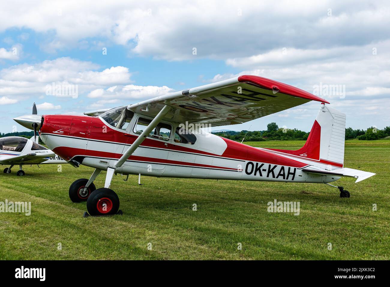 A Cessna 180 Skywagon aircraft parked on a field Stock Photo
