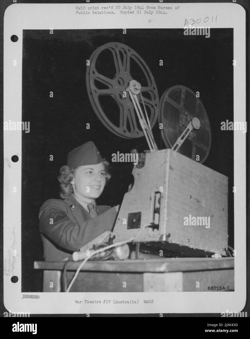 PROJECTIONIST. WAC T/Sgt. Dixie M. Eckels of Los Angeles, California, knows and like the job