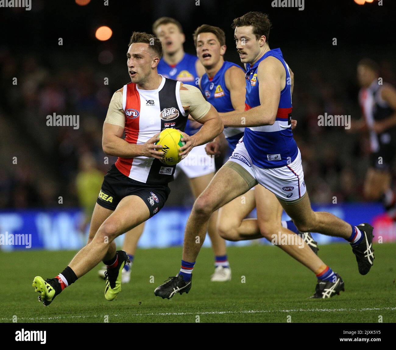 Luke Dunstan of the Saints (left) controls the ball in front of Zaine ...