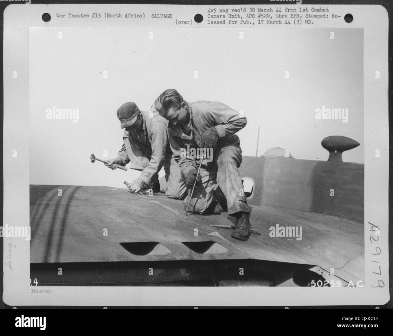 North Africa-Salvage yard personnel prepare outer wing of B-25 for