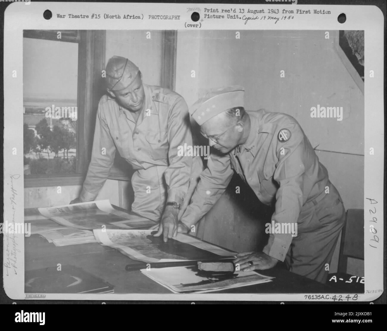 Colonel Elliott Roosevelt and General Dwight D. Eisenhower study aerial photographs of strategic points. NORTH AFRICA. Stock Photo