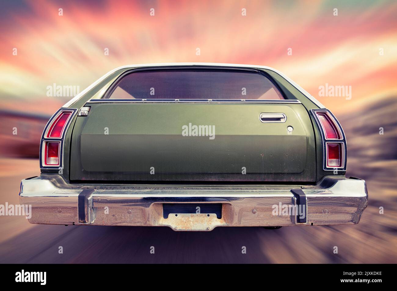 Classic Vintage Ford Gran Torino Station Wagon. Rear view in motion, driving into the sunset Stock Photo