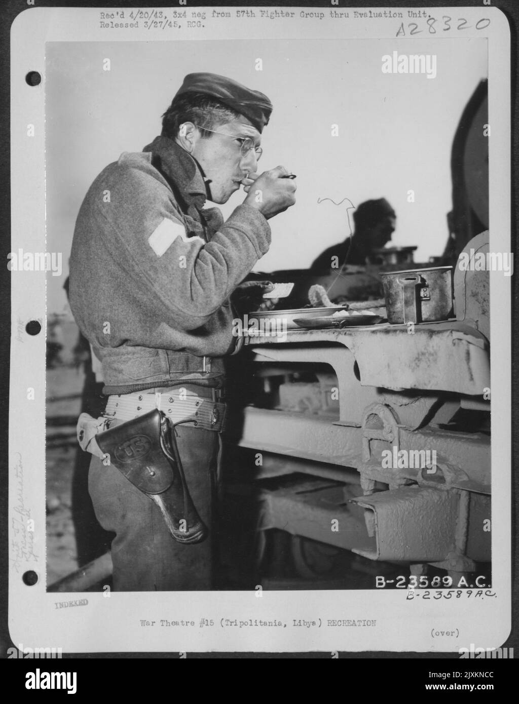"Chow time." Time out is taken by members of the 57th Fighter Group in