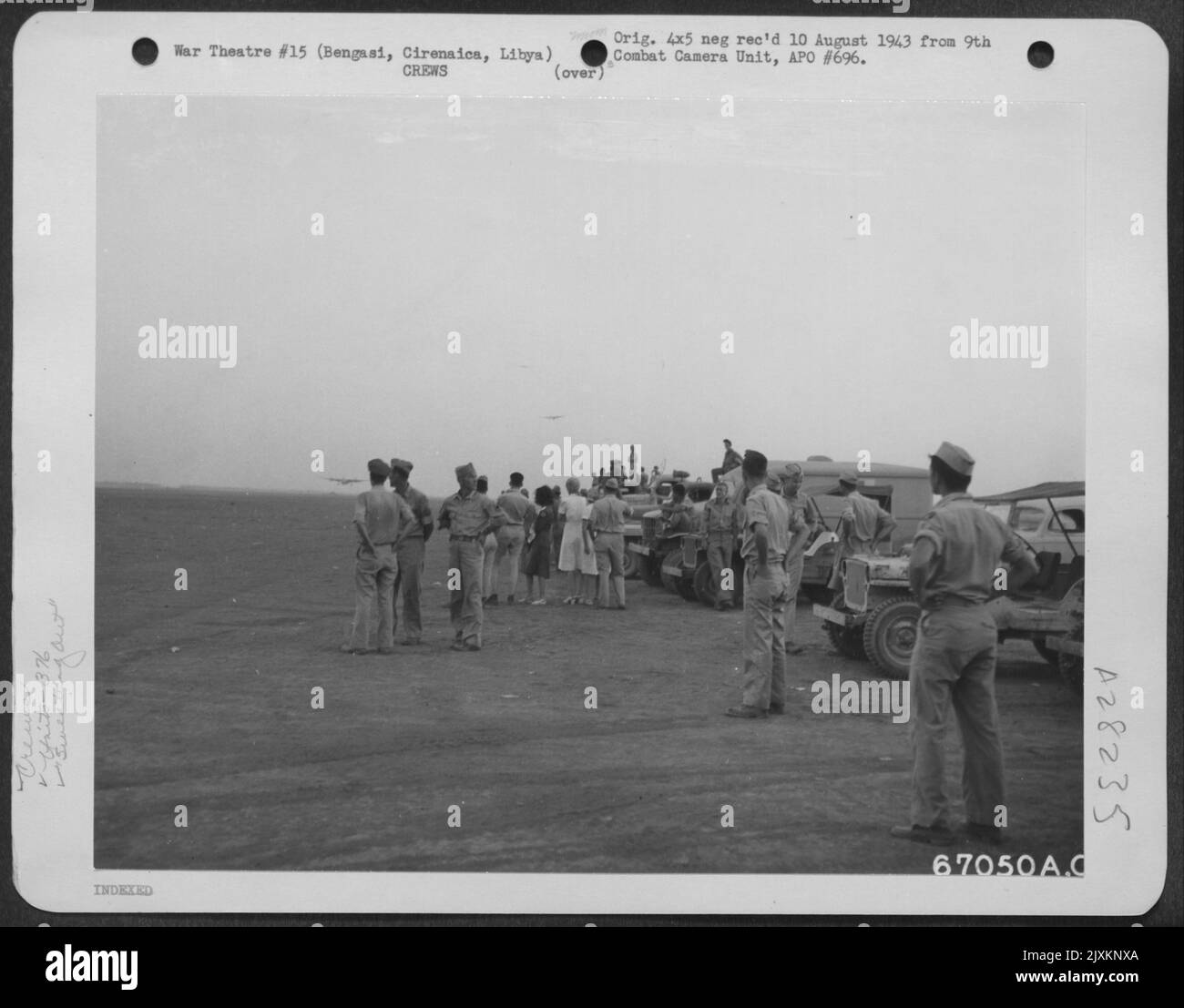 Crowd of ground crew members of the 376th Bomb Group at an air base ...