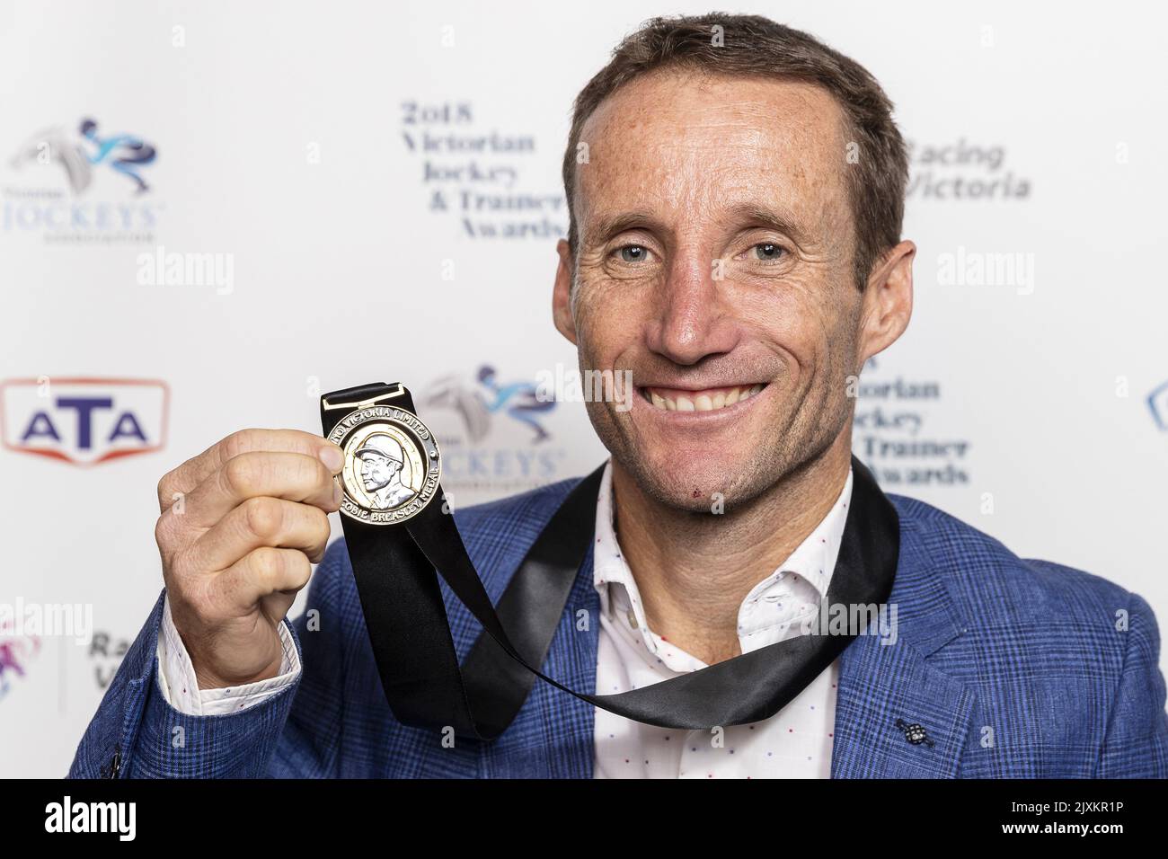 Damien Oliver poses for a photograph with the Scobie Breasley Medal