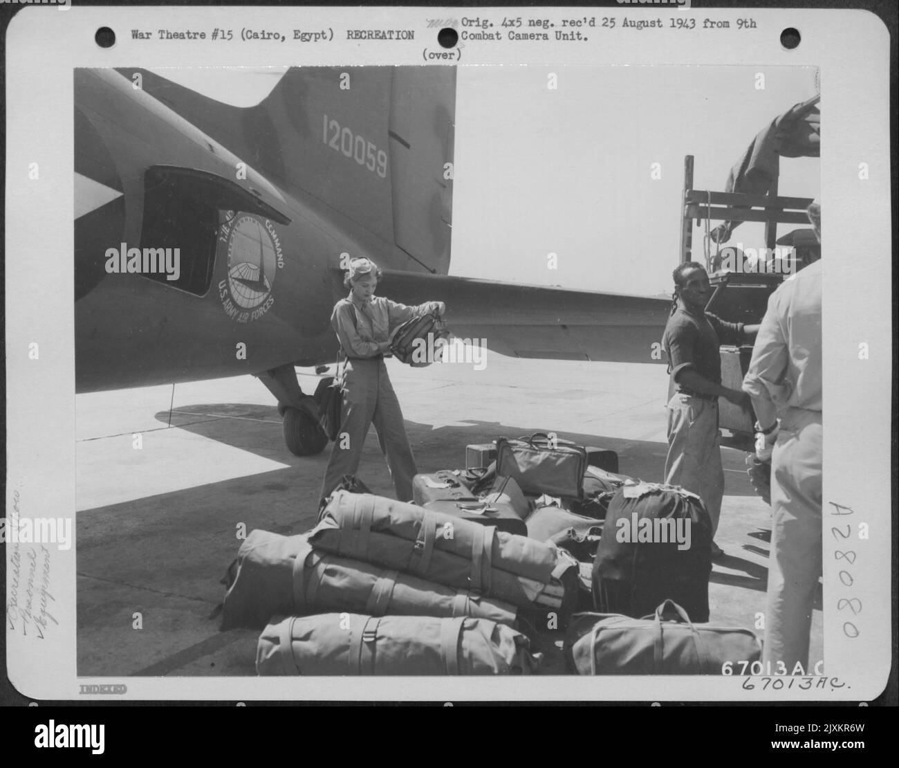 Anna Lee, a member of Jack Benny's show troupe, looks over the luggage