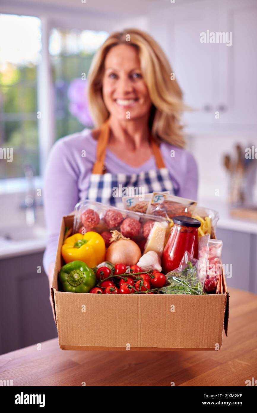 Portrait Of Mature Woman Unpacking Online Meal Food Recipe Kit
