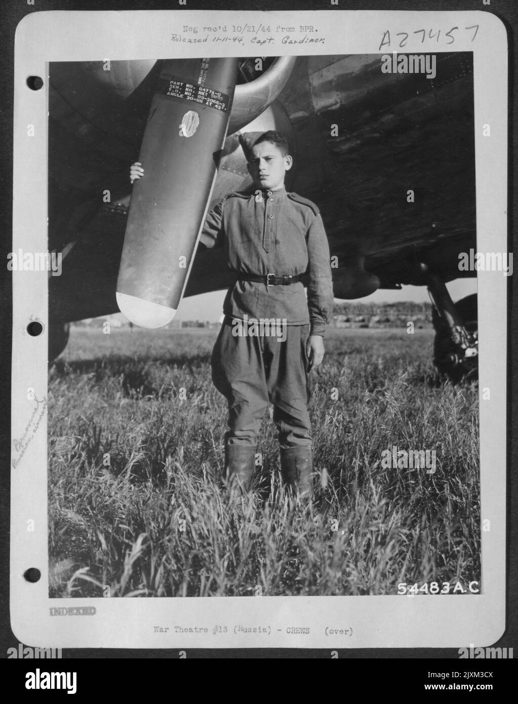 Majer Gildyngoryn, a young 15 year old Polish soldier stands beside a Boeing B-17. This youngster has been fighting the Germans since he was 11 years old. He saw his own mother killed by the Germans and immediately enlisted in the Polish Partisans. Stock Photo