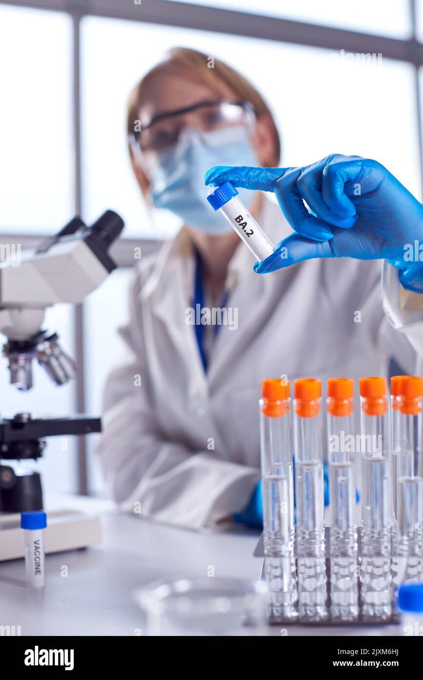 Female Lab Research Worker Wearing PPE Holding Test Tube Labelled BA.2 ...