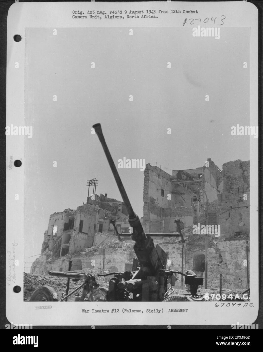 An American ackack gun, surrounded by bomb damaged buildings, is ready