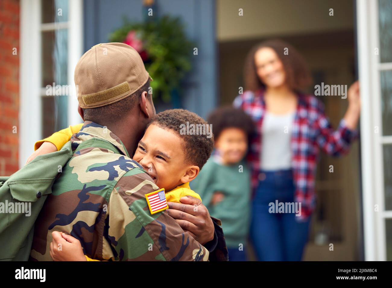 American Soldier In Uniform Returning Home To Family On Hugging ...